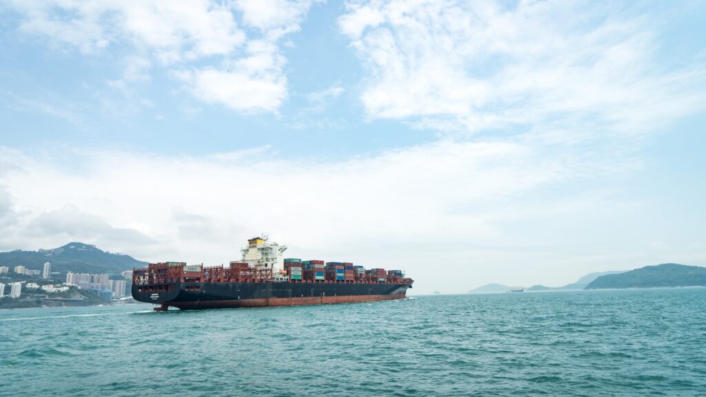 cargo ship with shipping containers at sea